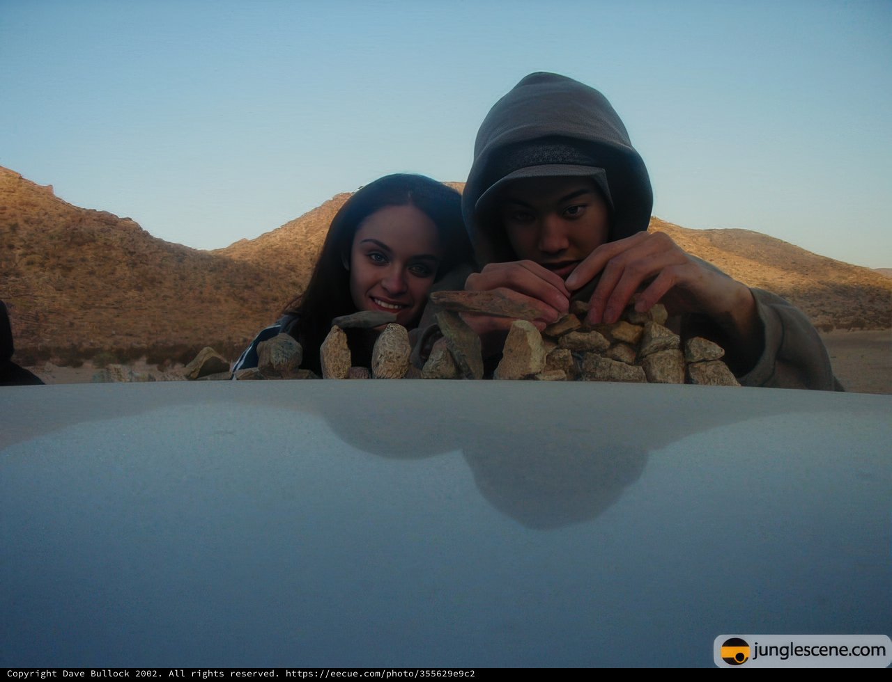 Sitting on the Hood of a Car in the Desert