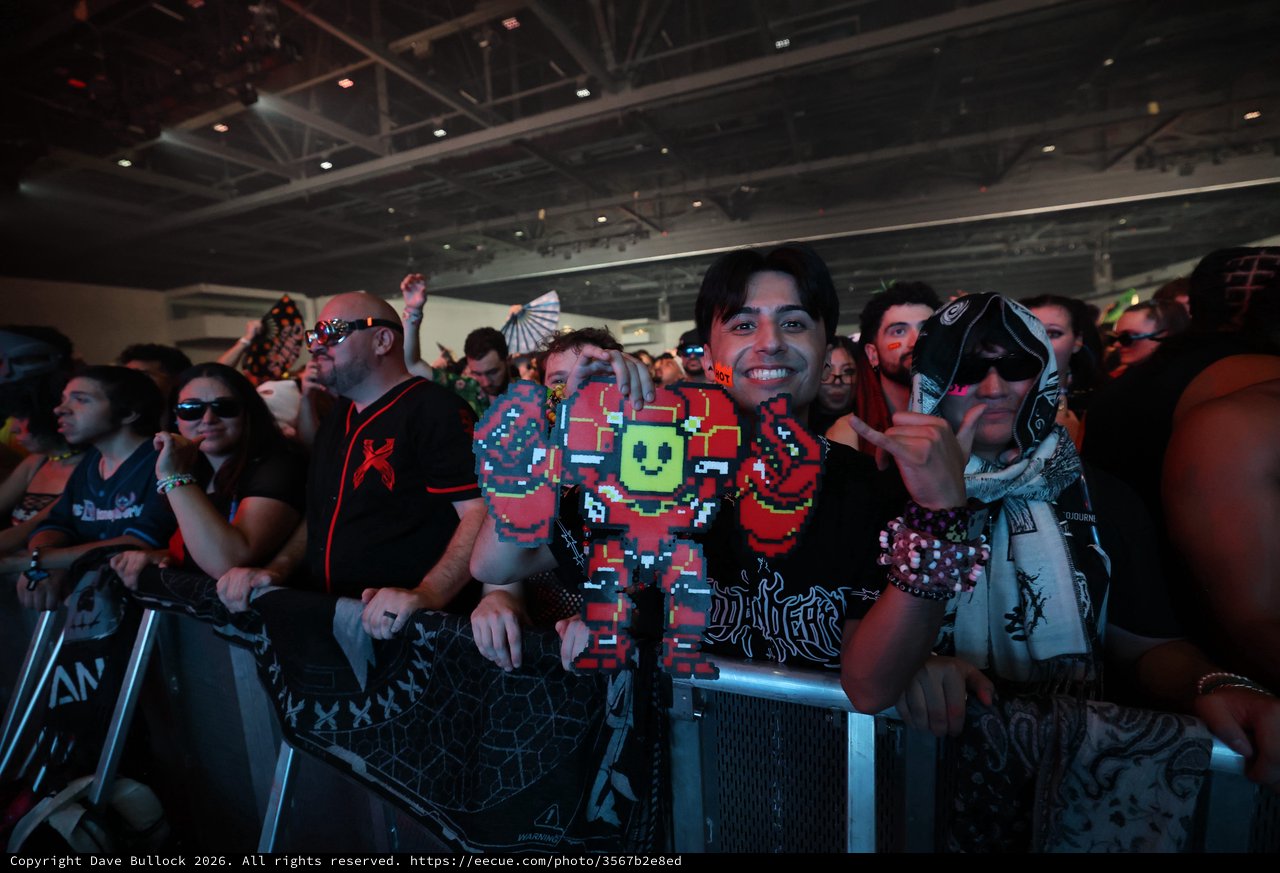 Smiling Fan Holds Pixel Art Figure at Wobbleland 2026