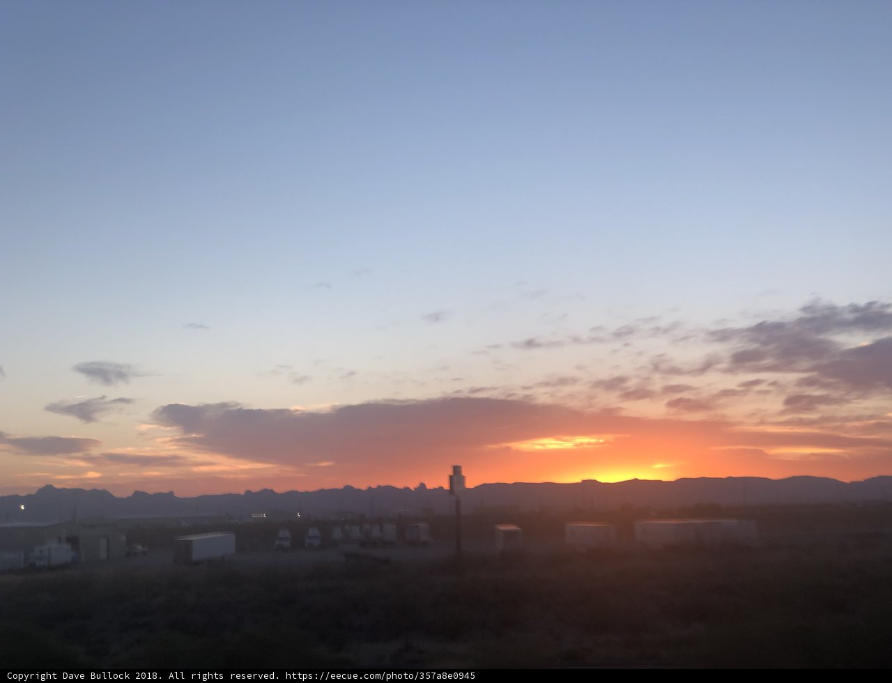 Train Silhouetted by a Vibrant Desert Sunset
