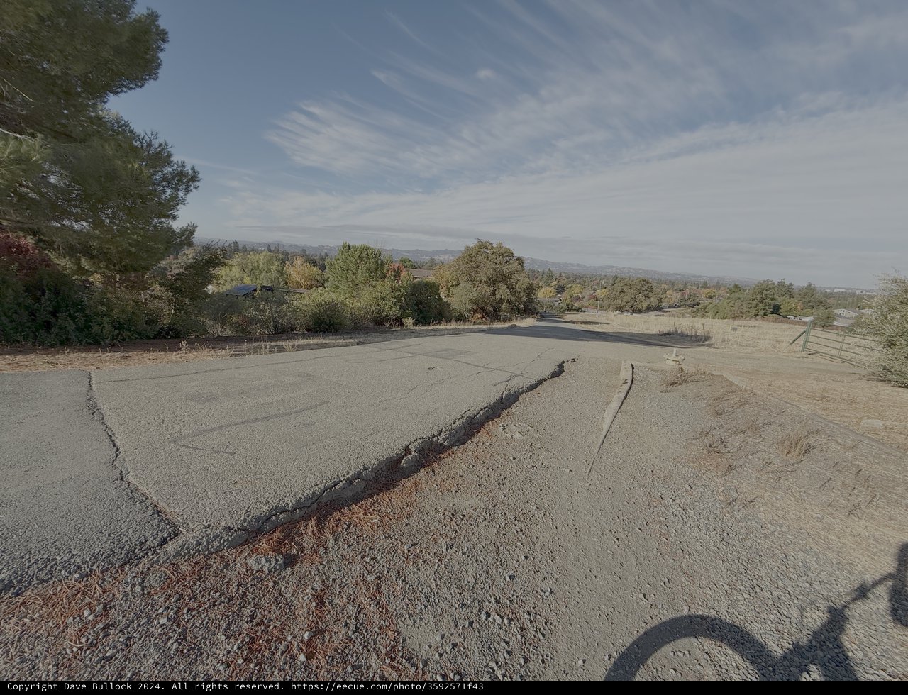 Cracked Asphalt Road in Rural Setting