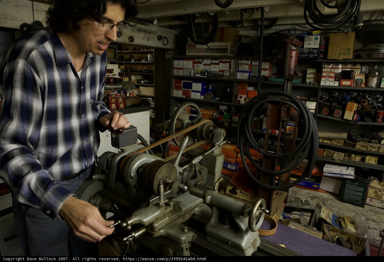 Man Using Machine to Create Tools in Workshop