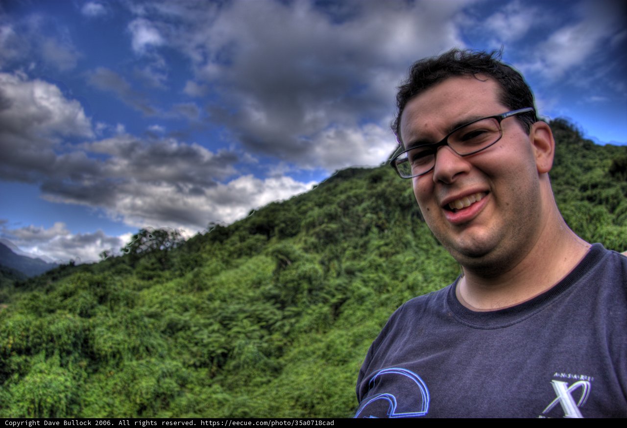 Smiling Man with Glasses in front of Majestic Mountain