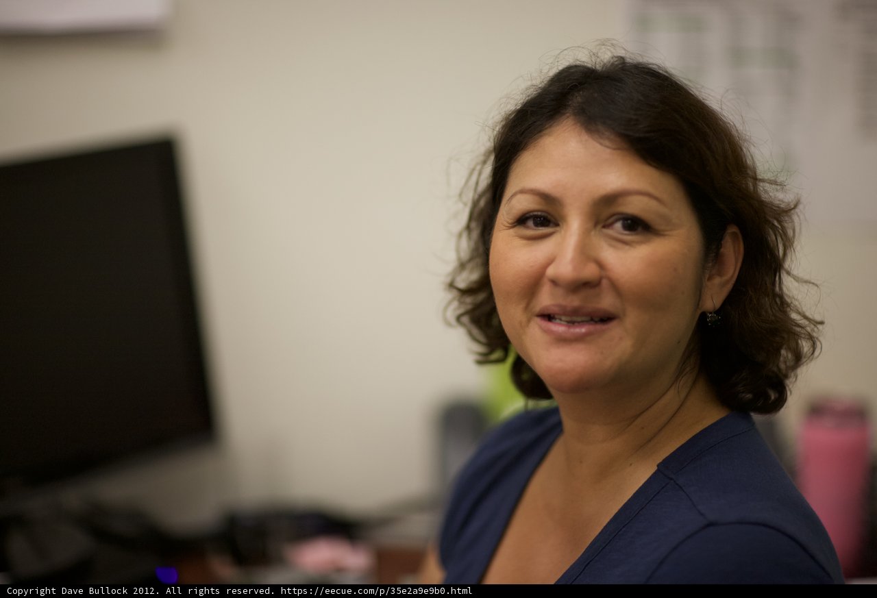 Smiling Woman in Blue Shirt