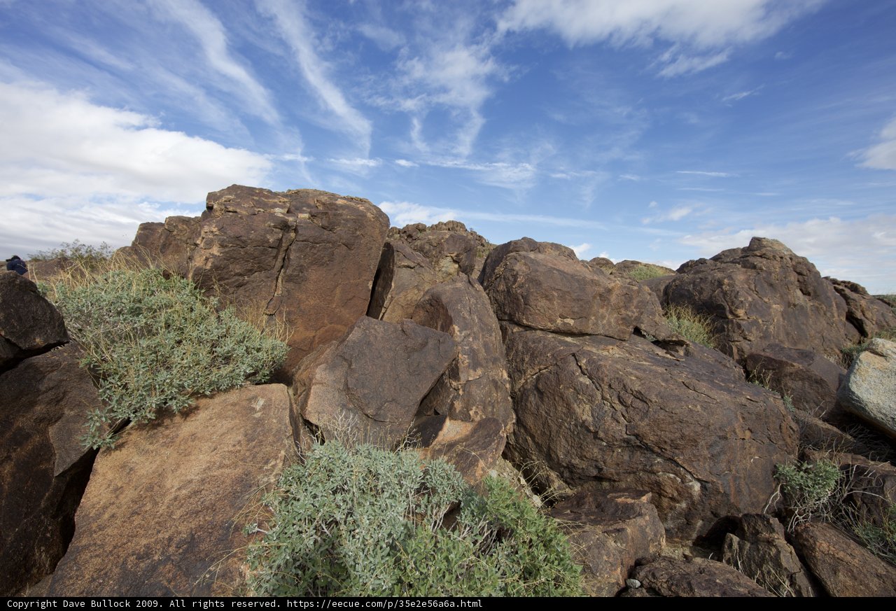 Rocky Hillside under a Cloudy Blue Sky