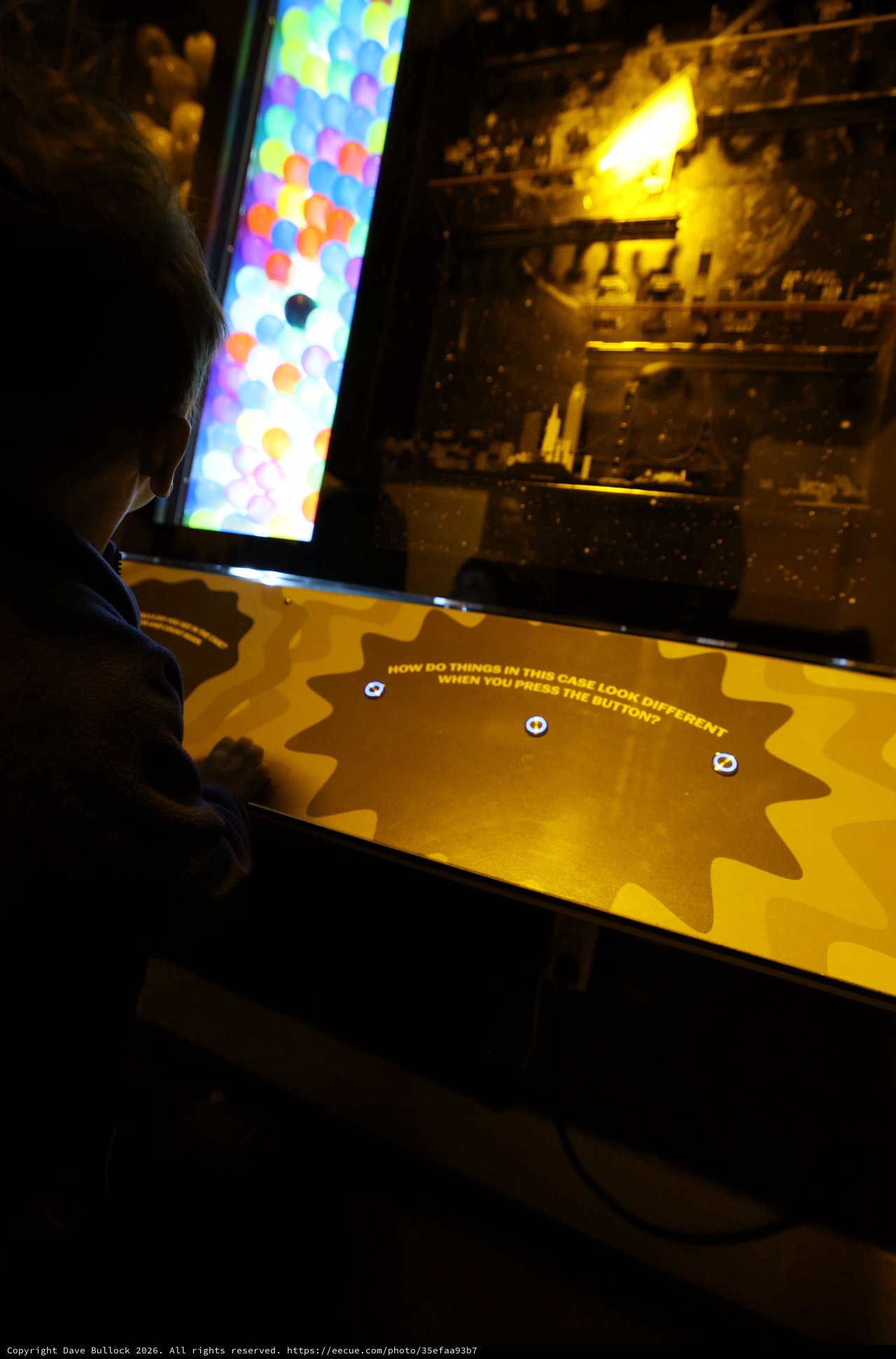 Child Exploring Interactive Museum Display at Night