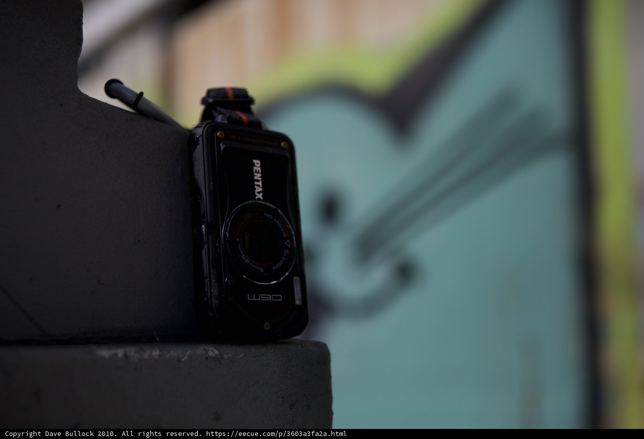 The Pentax W90 Camera Rests on a Ledge