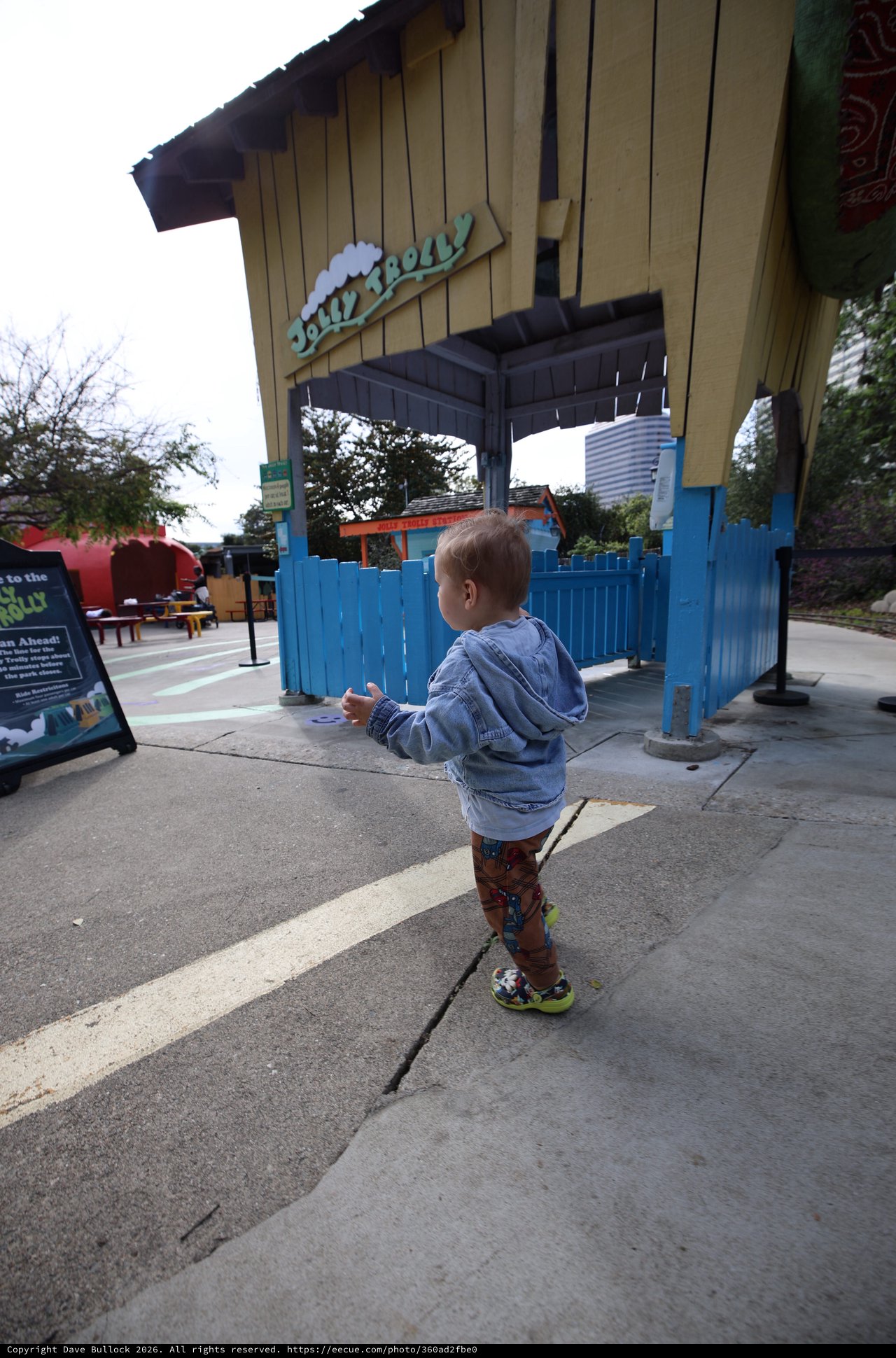 Young Child Exploring Jollity Hall Entrance at Theme Park