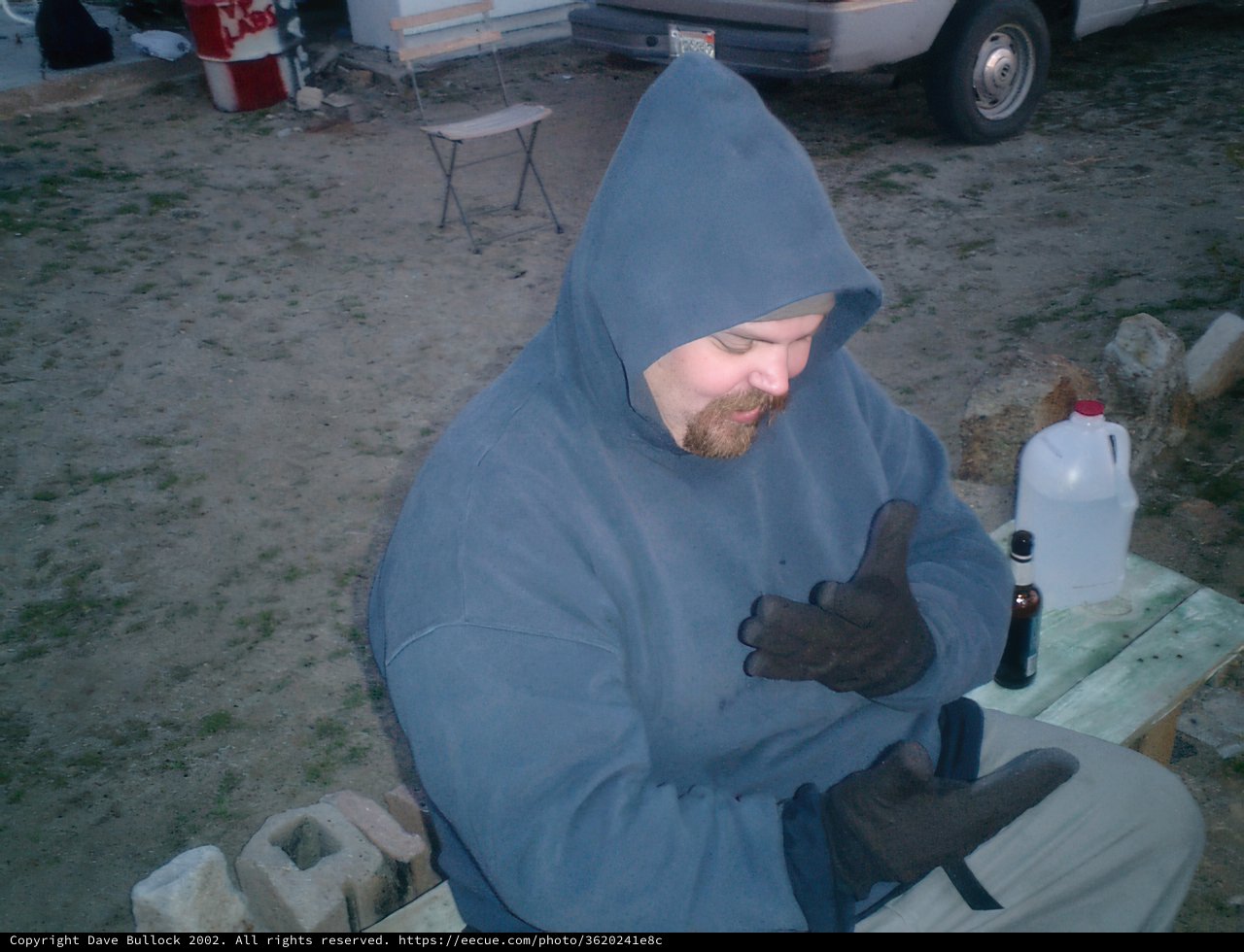 Hooded Man on a Lone Bench
