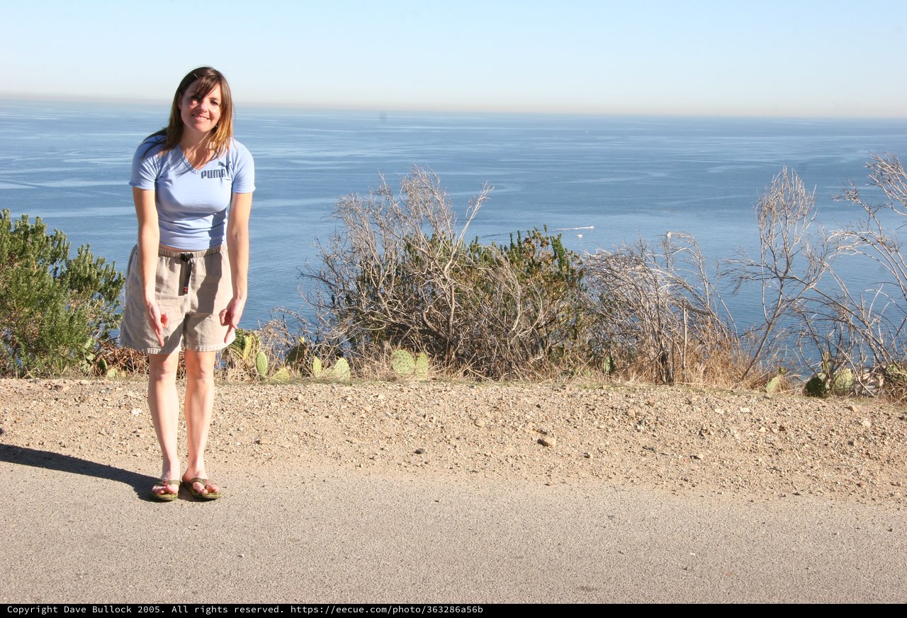 Woman Smiling at Coastal Overlook with Ocean Views