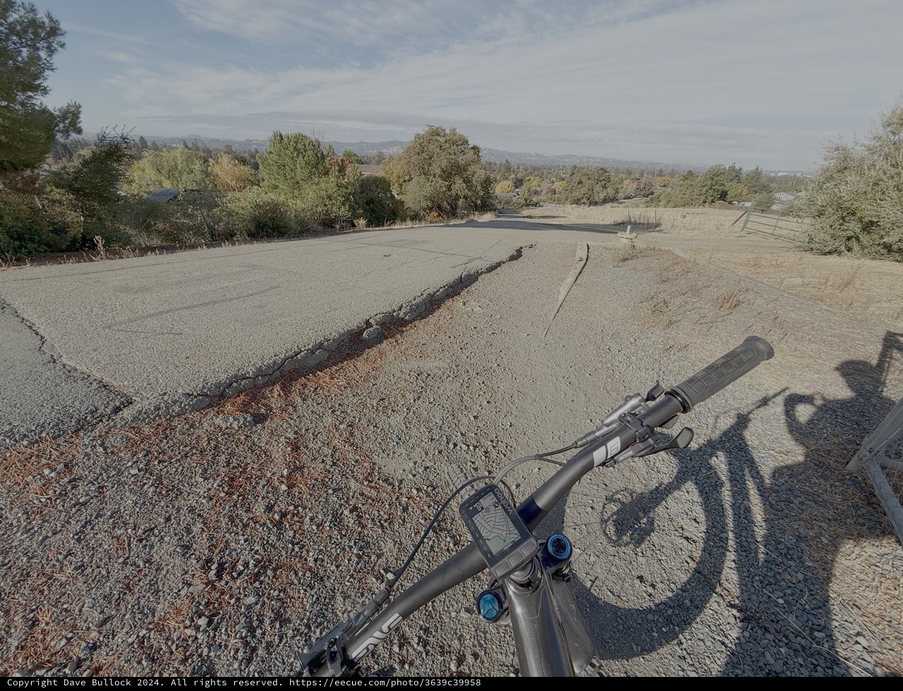 Cyclist's View of Cracked Desert Road