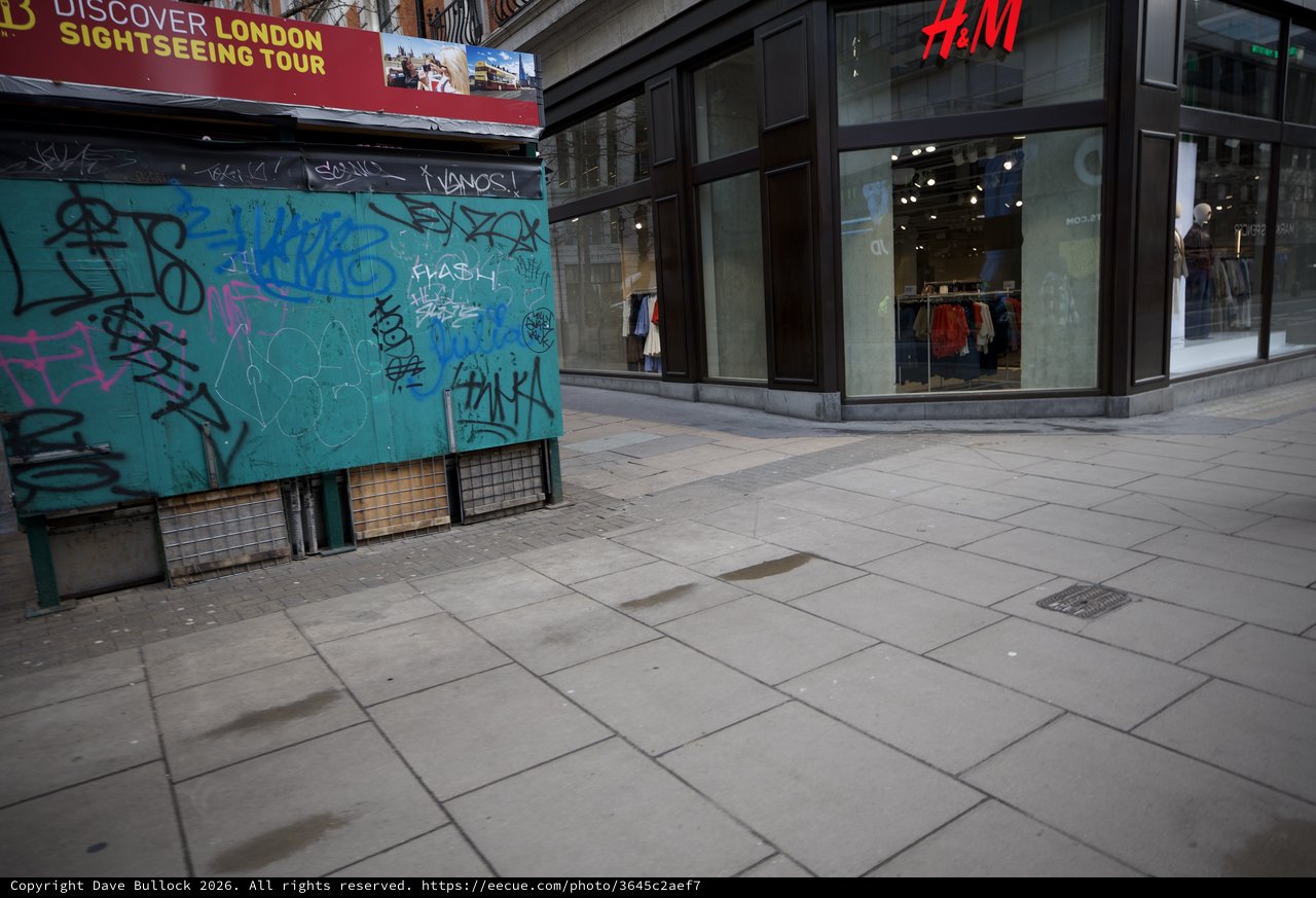 Urban Streetscape with Graffiti Kiosk and H&M Store