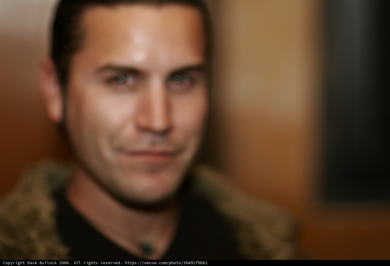 Blurry Portrait of Smiling Man in Black Shirt