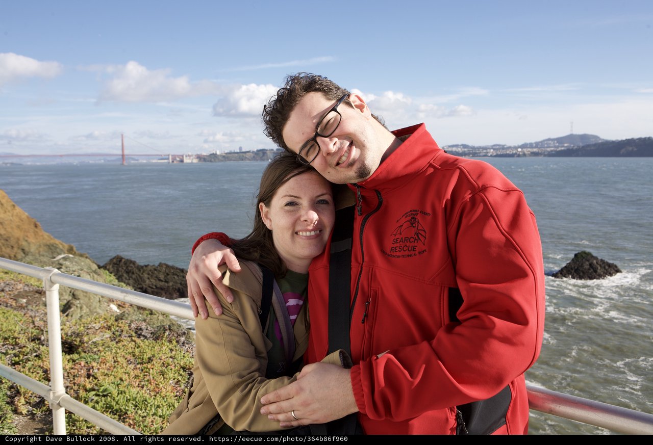 Couple Embracing with Golden Gate Bridge Behind