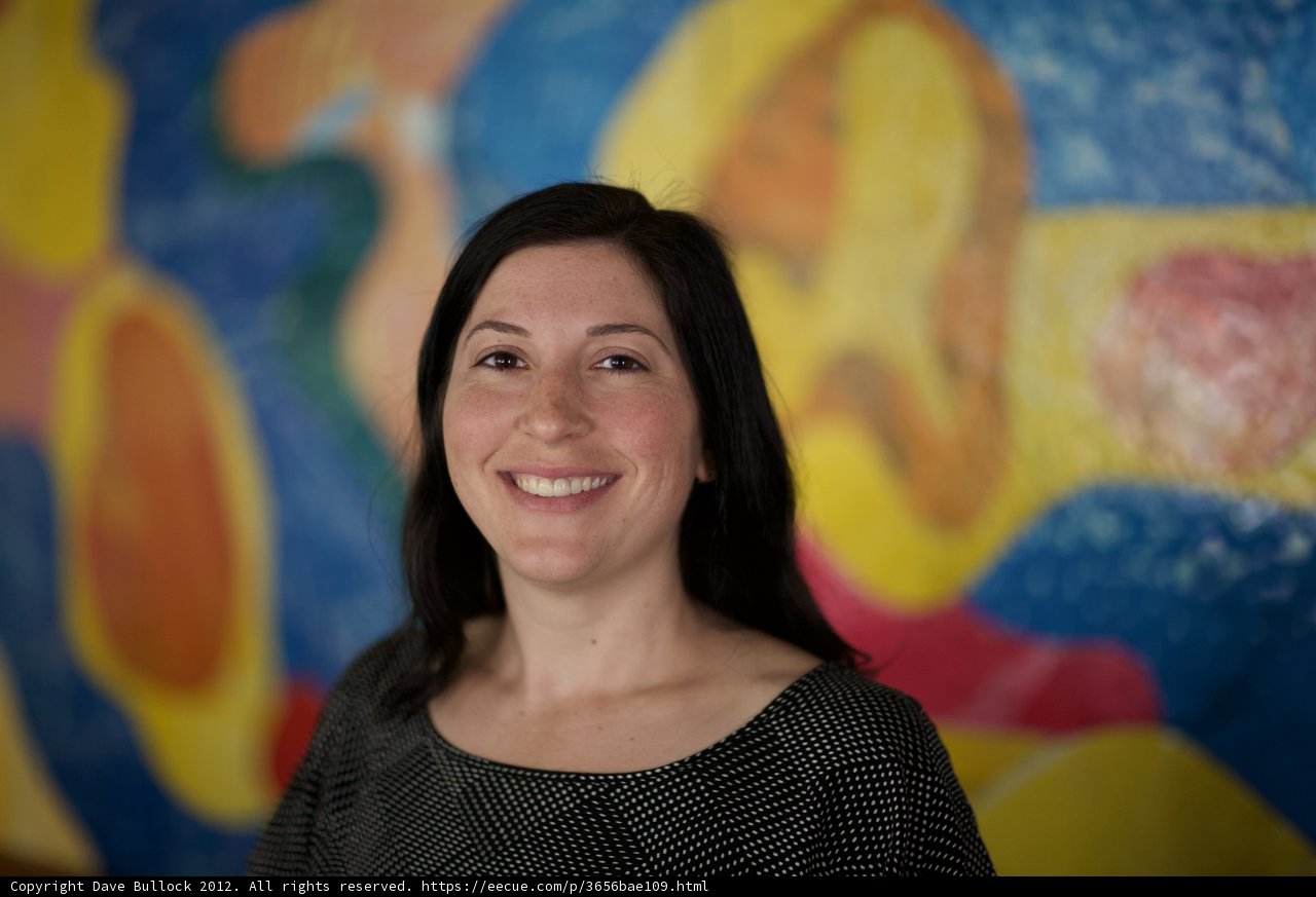 Happy Woman in Front of Colorful Painting