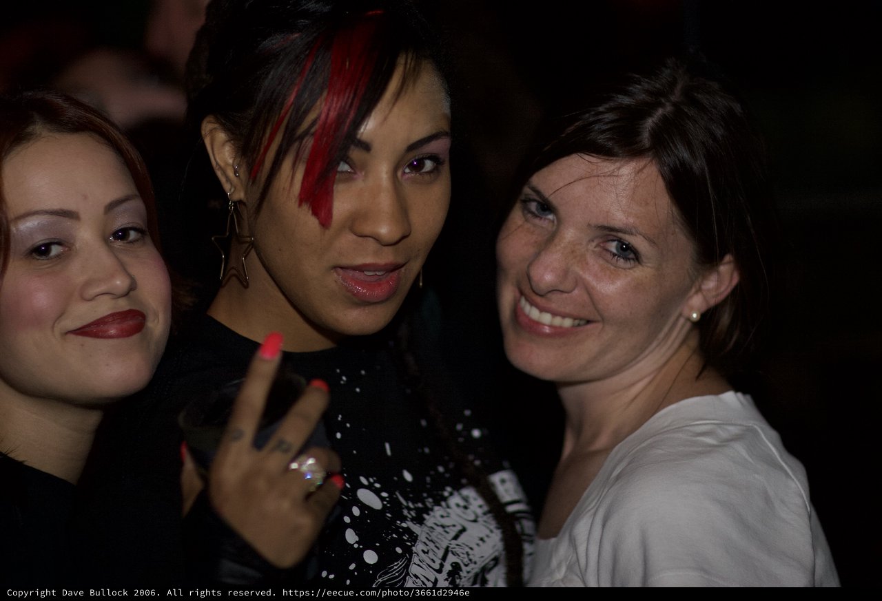 Three Women Posing Together at Nightclub Party