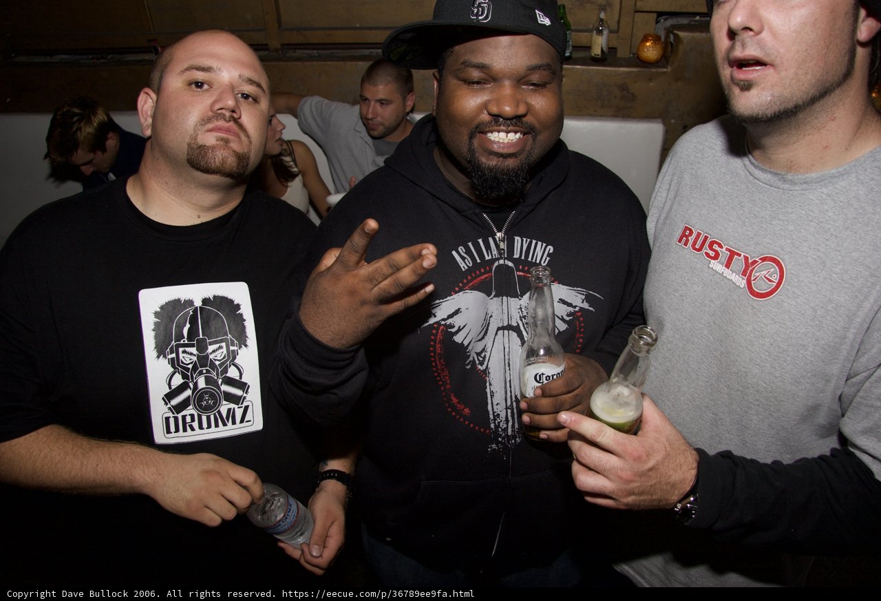 Three Men Raise A Beer Toast At A Party