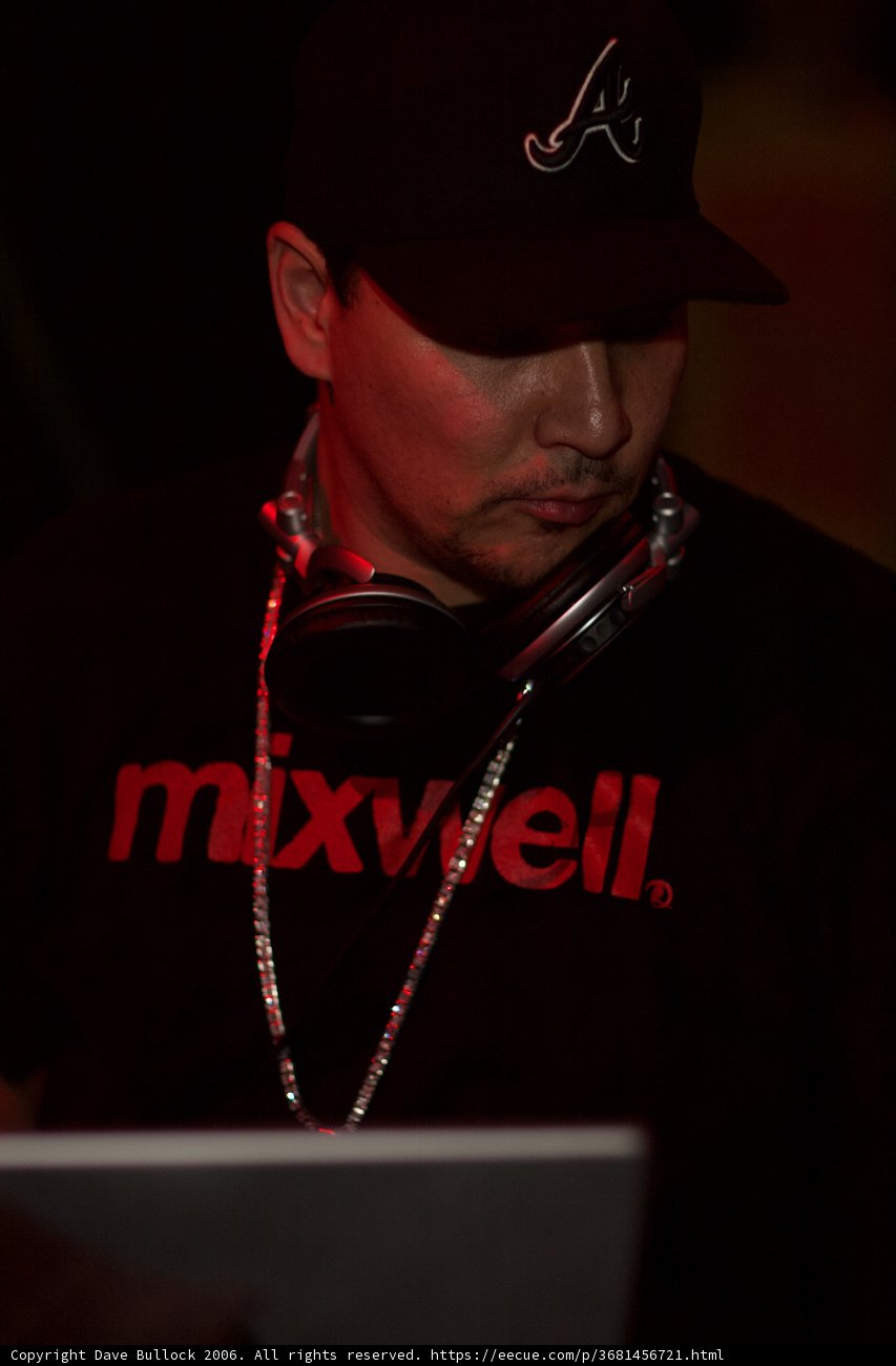 Black Shirted Man with Baseball Cap using Laptop
