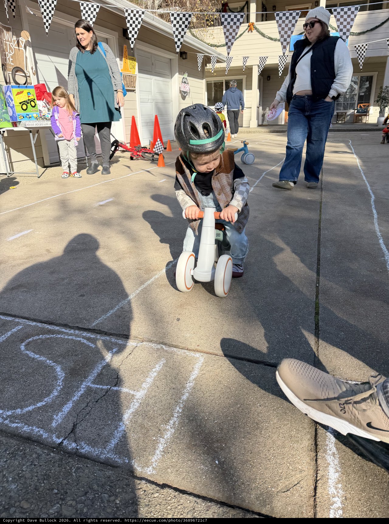 Young Child Racing on Scooter at Backyard Party