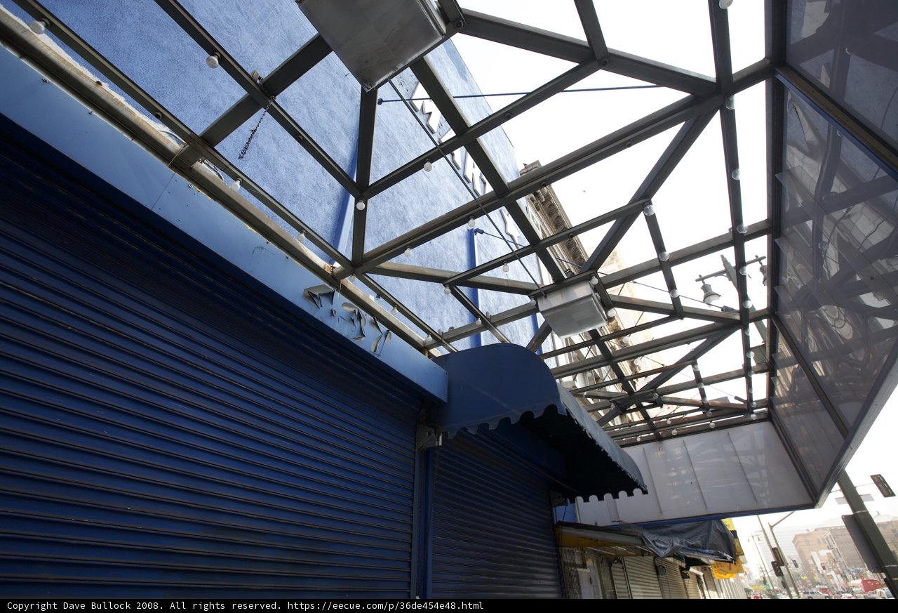 Blue Building with Metal Roof and Sign