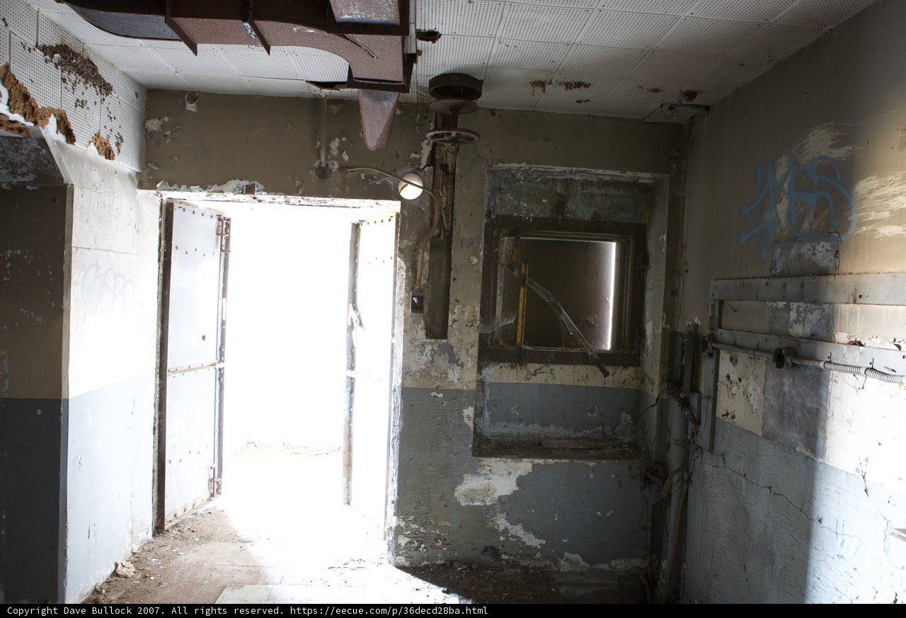 Graffiti-Adorned Doorway in Abandoned Bunker