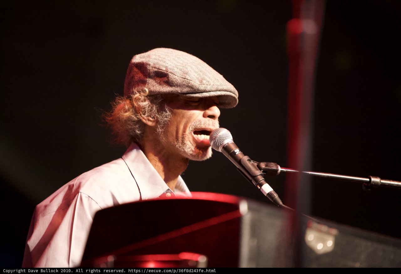 Hat-wearing man serenades crowd with keyboard