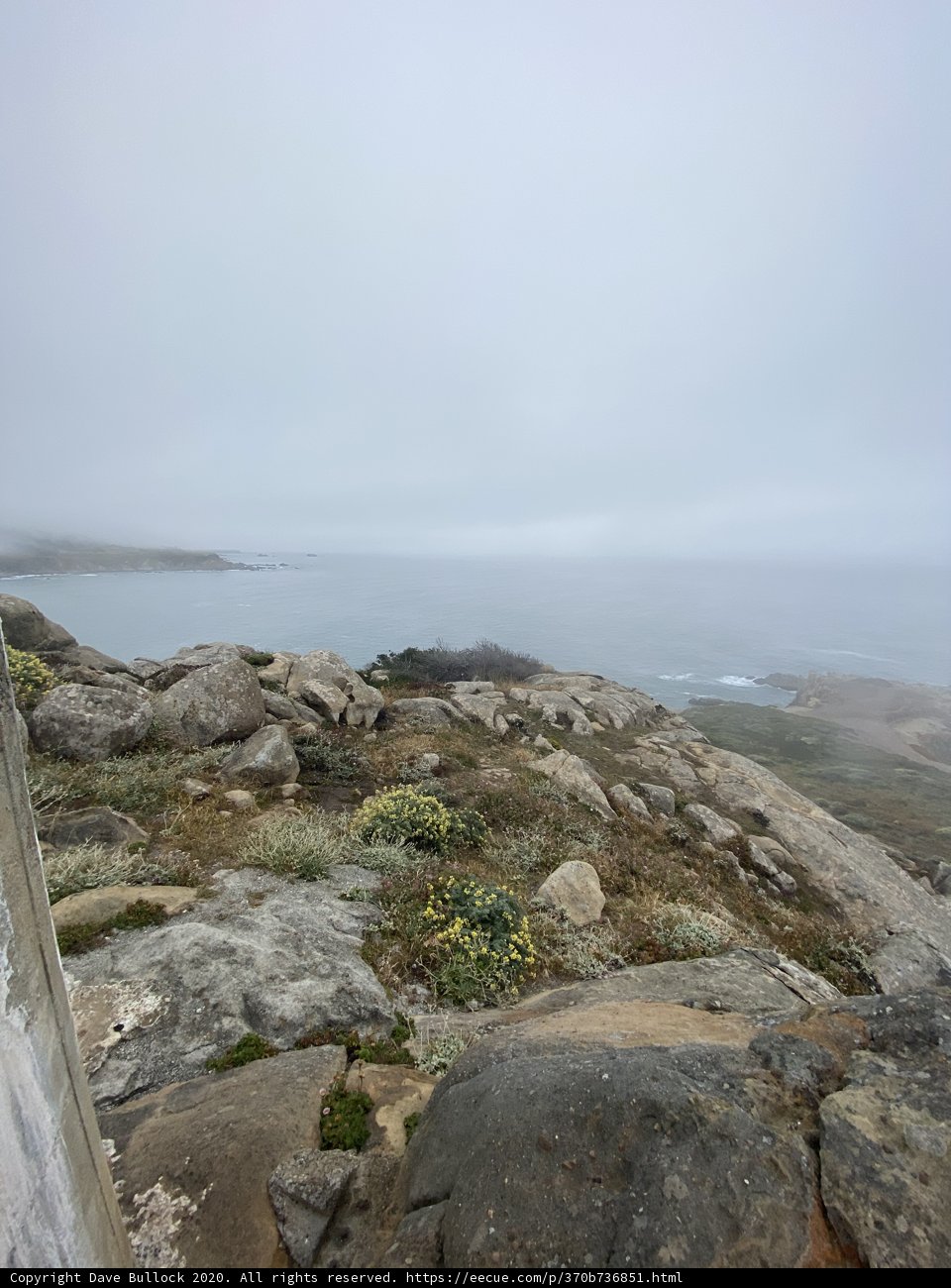 A Breathtaking View of the Turquoise Ocean from the Rocky Cliff