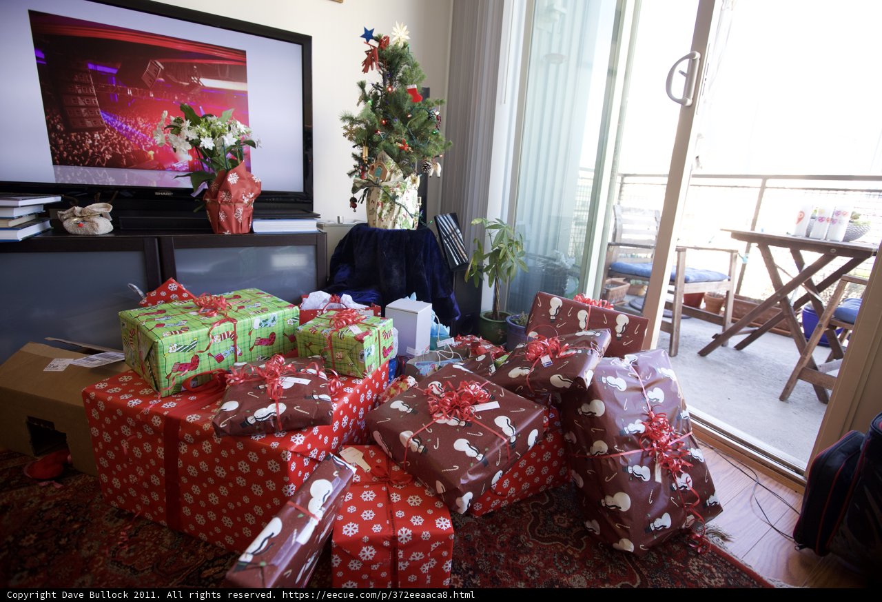 A Festive Living Room with Gifts and Greenery