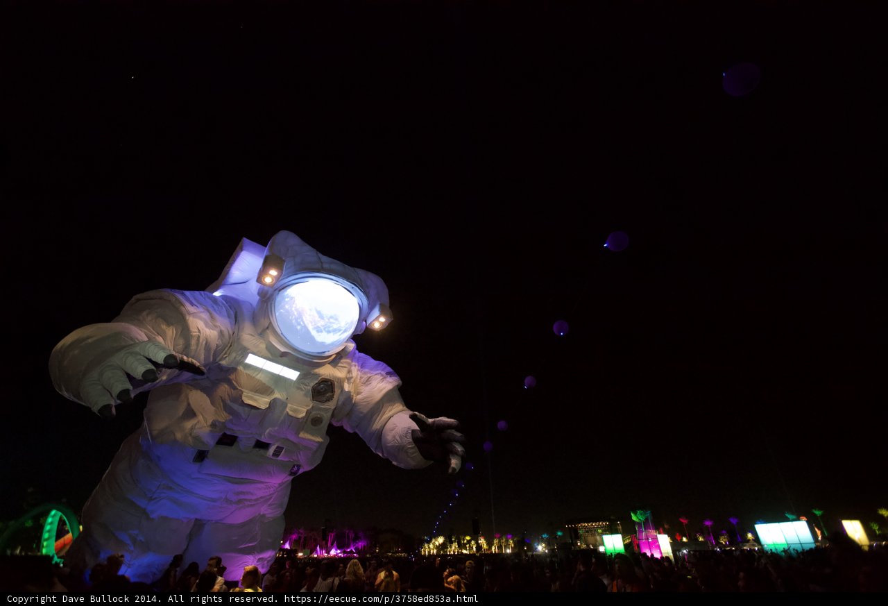 Astronaut Soaring over Coachella Crowd at Night