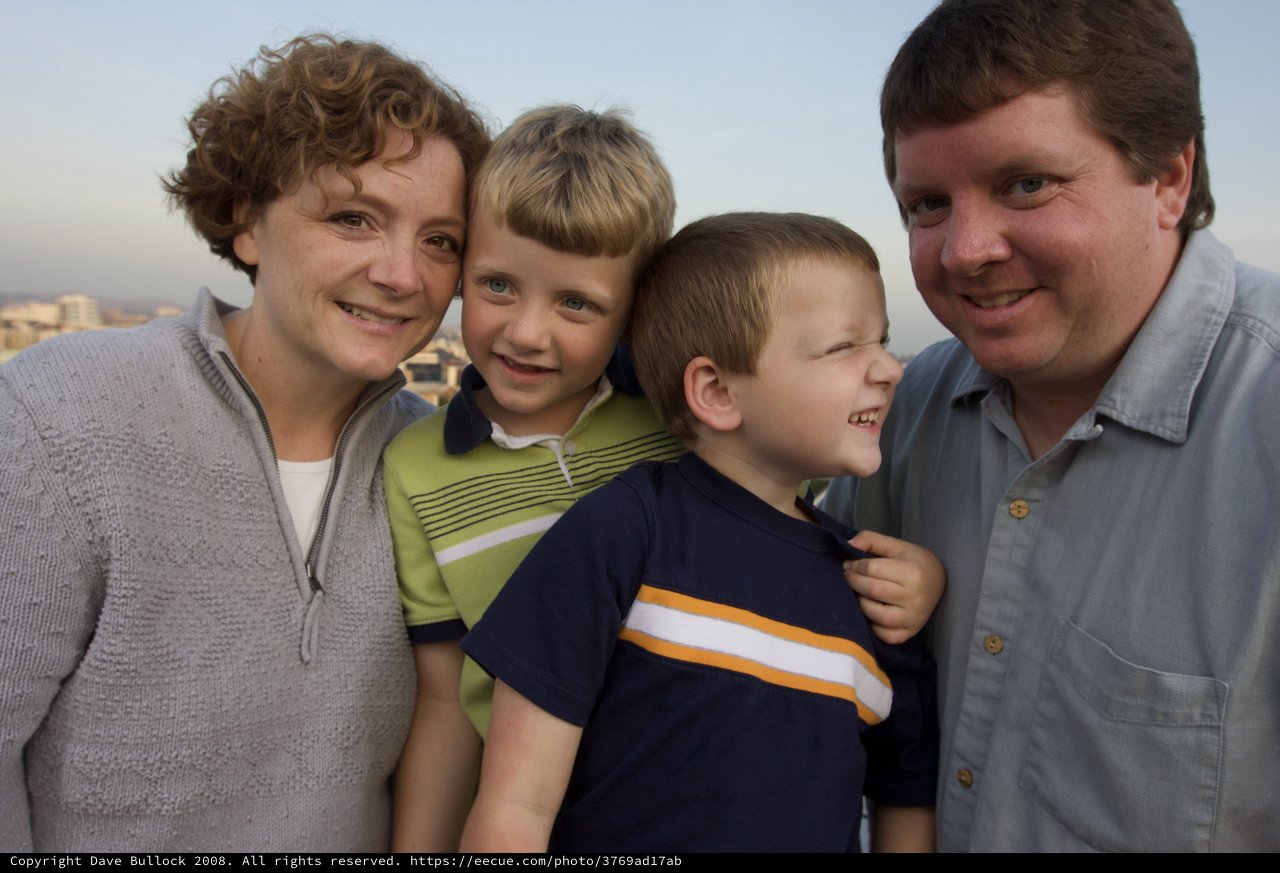 Happy Family Portrait at Sunset Overlooking the City