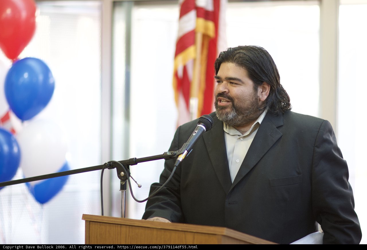 Man with Long Hair and Beard Delivering a Speech