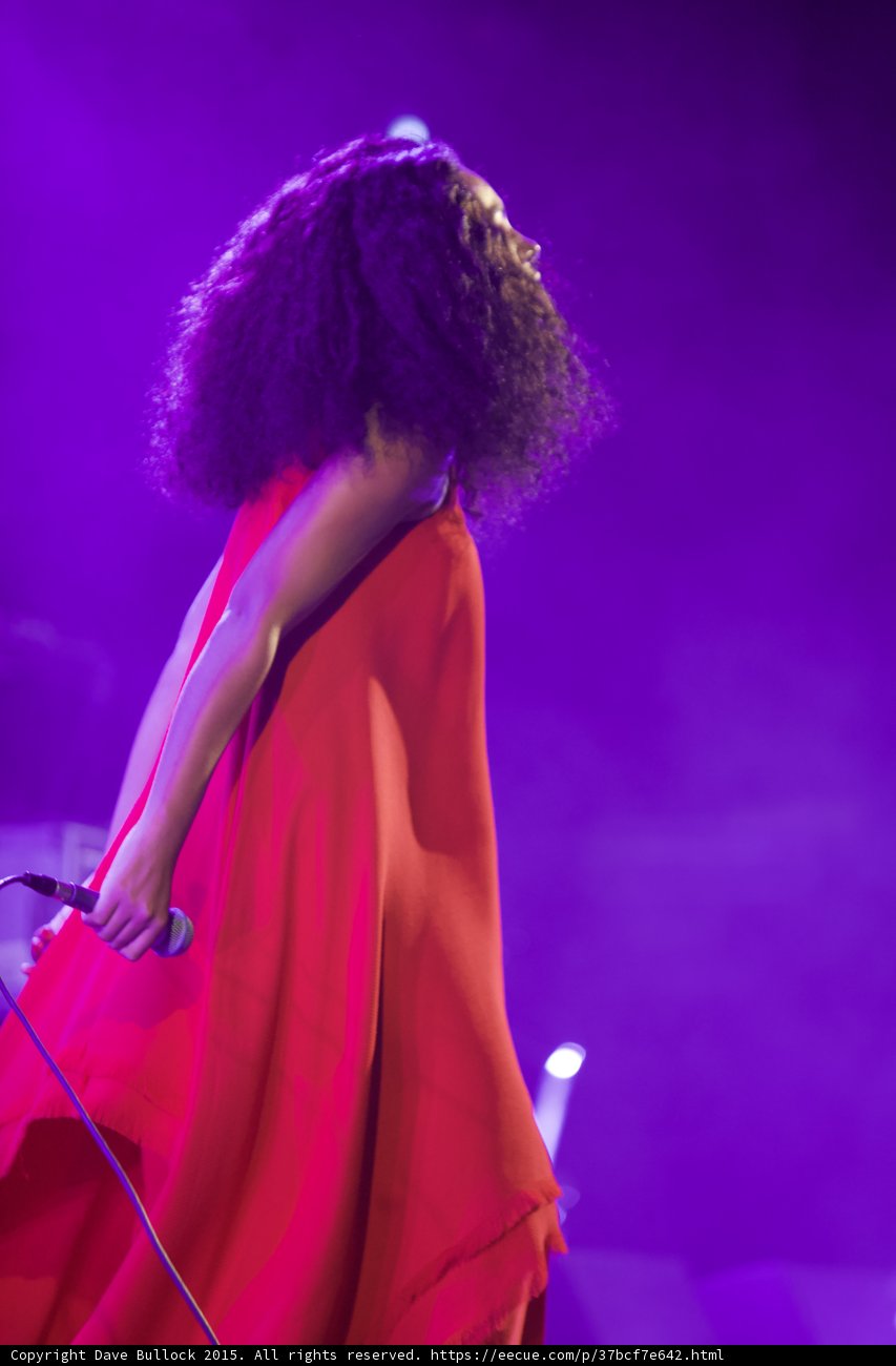 Solange Profile Looking Back Mic Down Red Dress Spotlight Purple