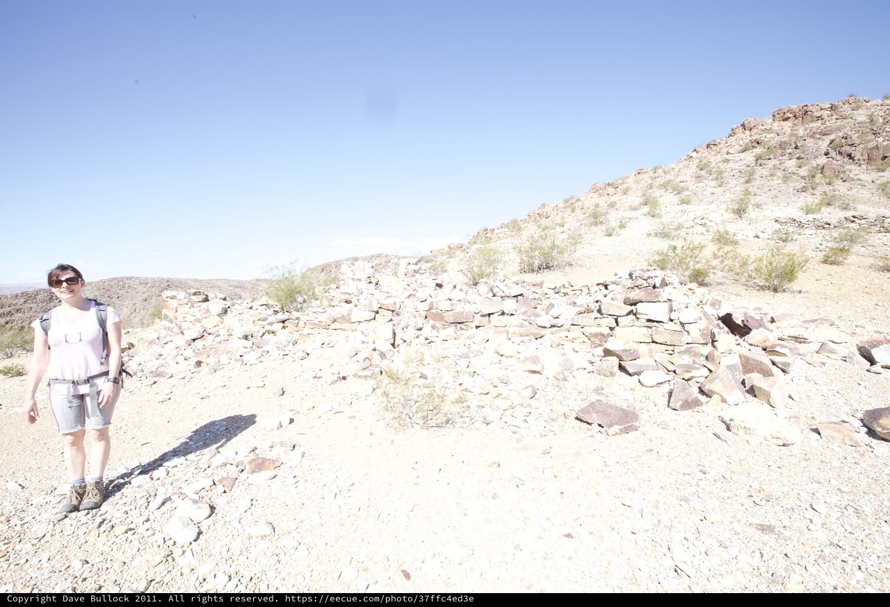 Desert Hiker Explores Ancient Stone Ruins in Arid Landscape