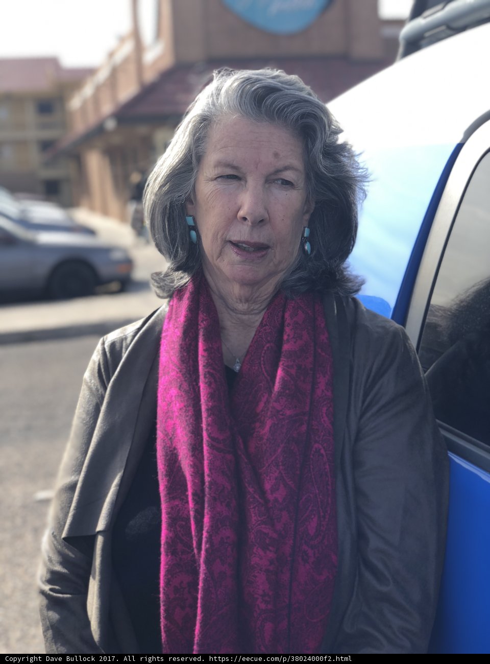 Blue car and a woman in a scarf