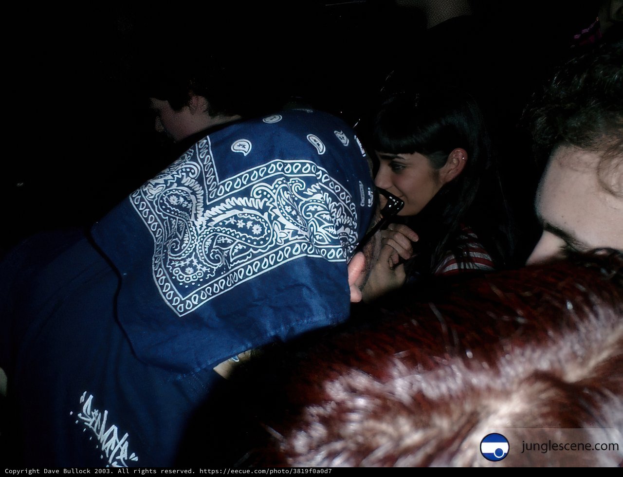 Bandana-Wearing Man Amongst Friends and Furry Companion