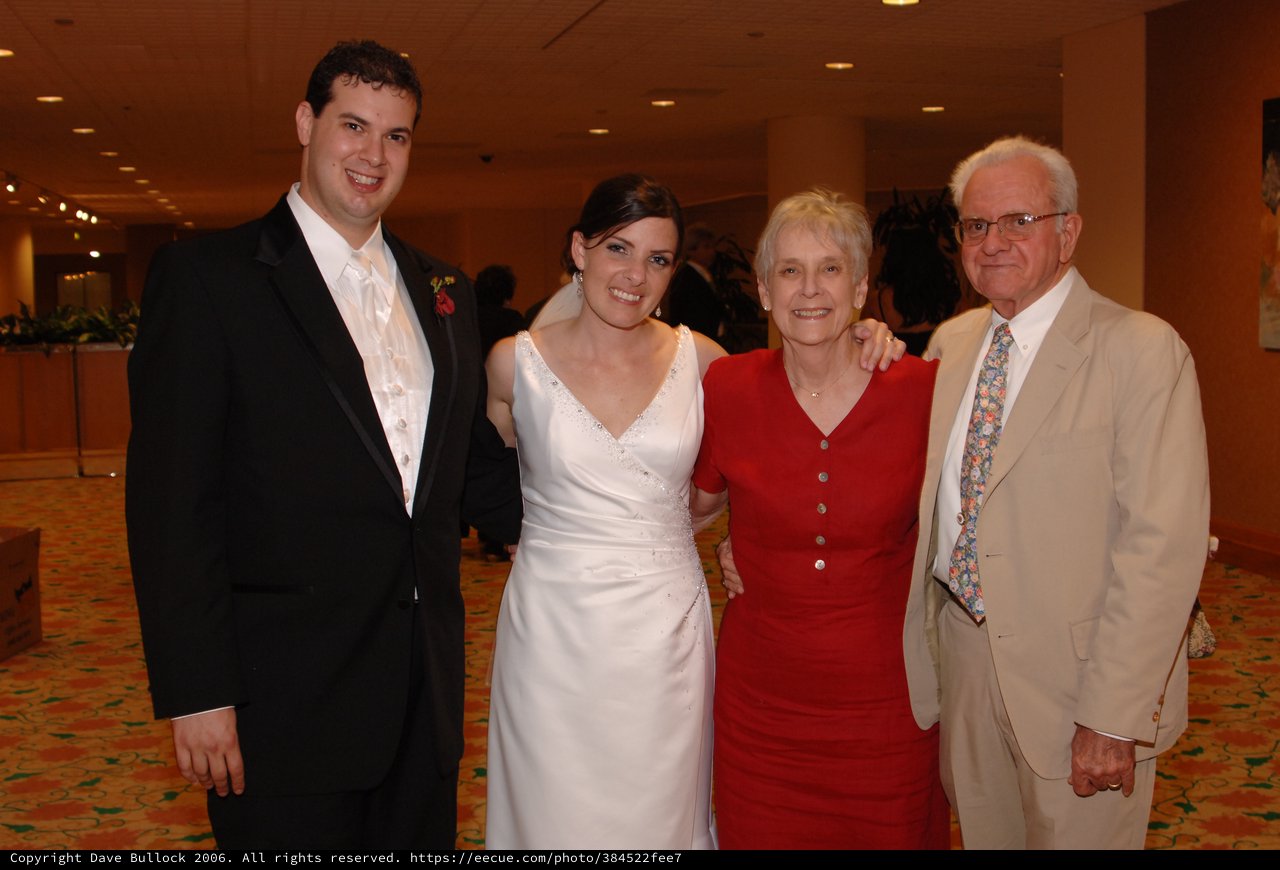 Newlyweds Pose with Grandparents at Wedding Reception