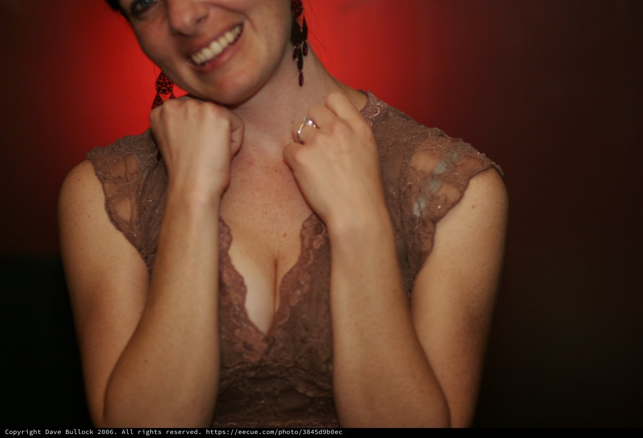 Smiling Woman in Lace Dress at Evening Event