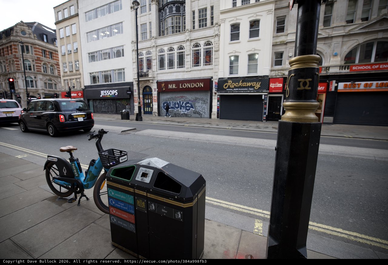 Urban Street Scene with Bike Share and Recycling Bin