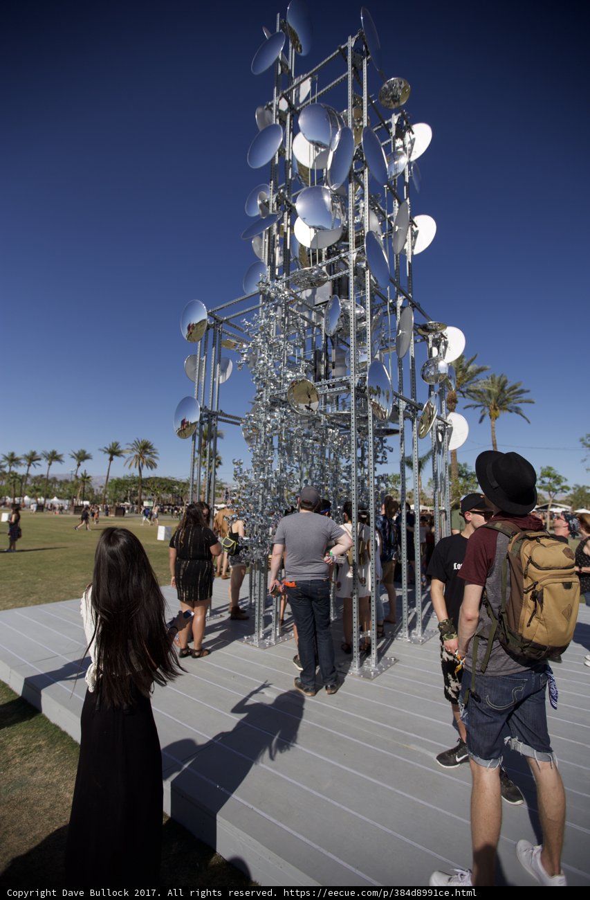 Group of People Admiring Metal Sculpture