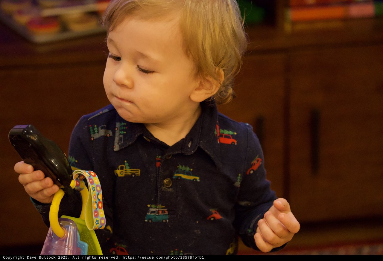Toddler Examining Dark Green Vegetable with Curiosity