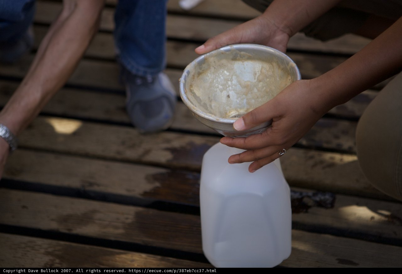 Pouring Milk into Wooden Container