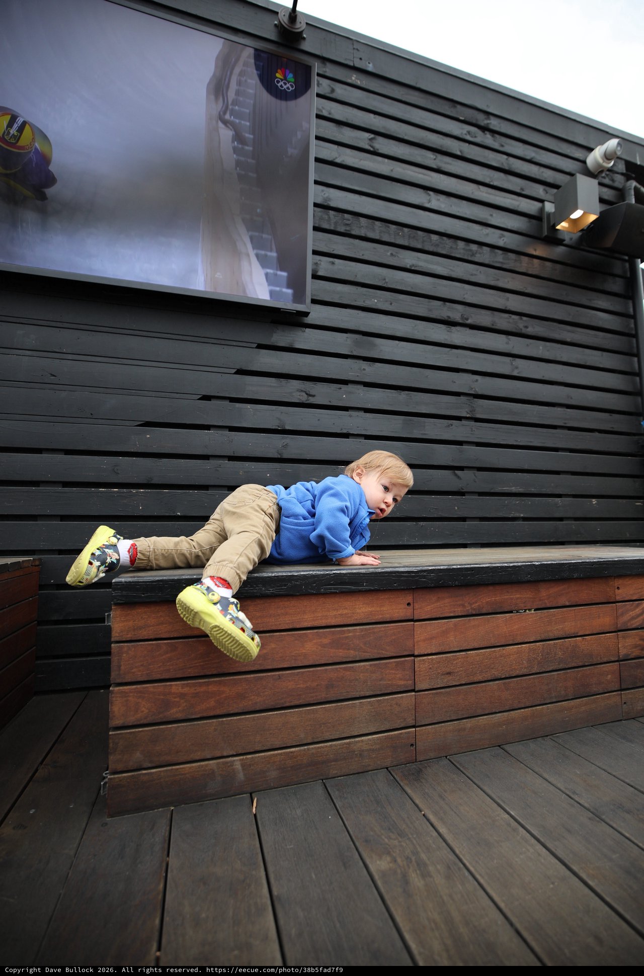 Young Child Climbing Modern Wooden Deck Structure
