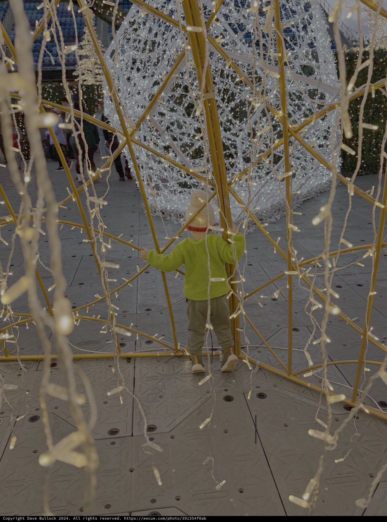 Child Exploring Interactive Golden Bamboo Art Installation