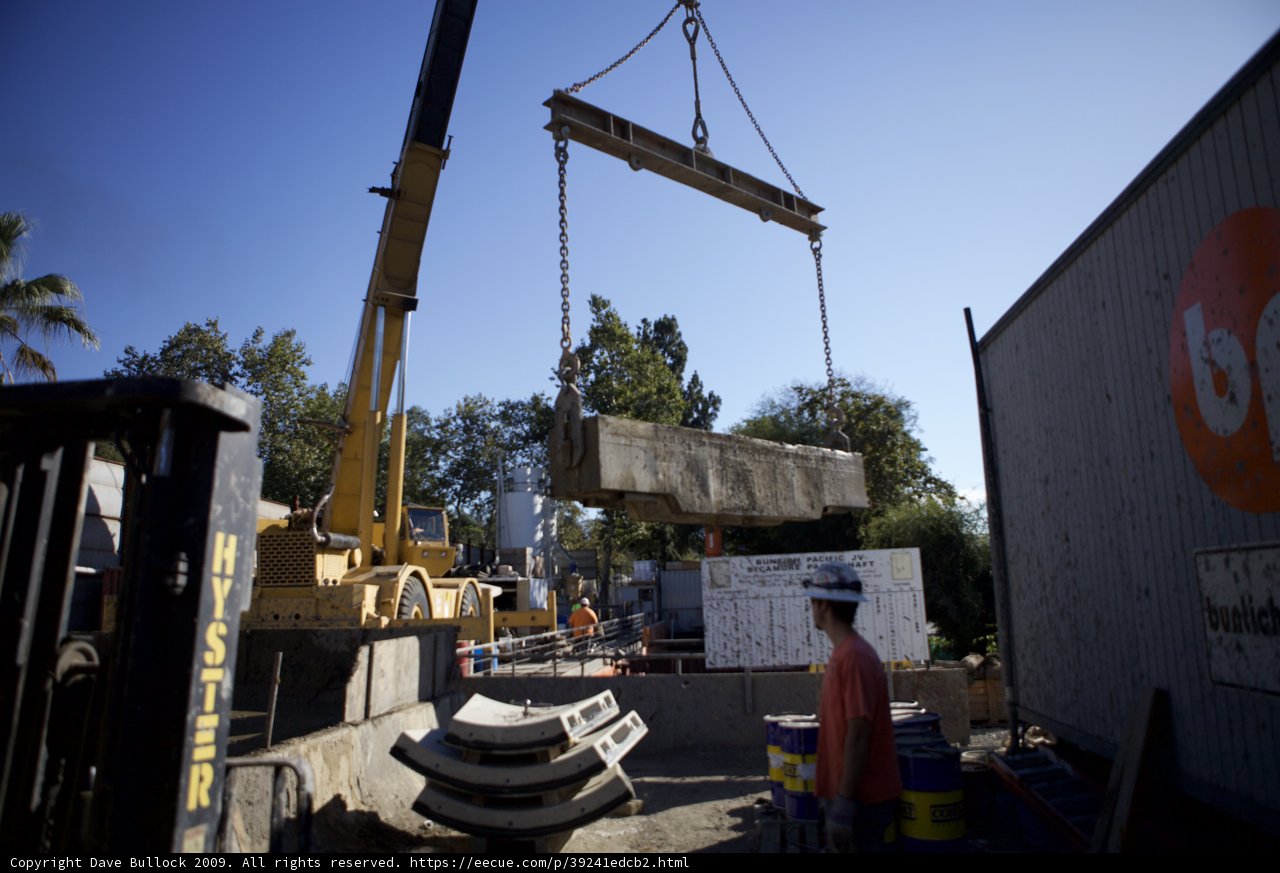 Construction Workers Lift Concrete Slab onto Truck