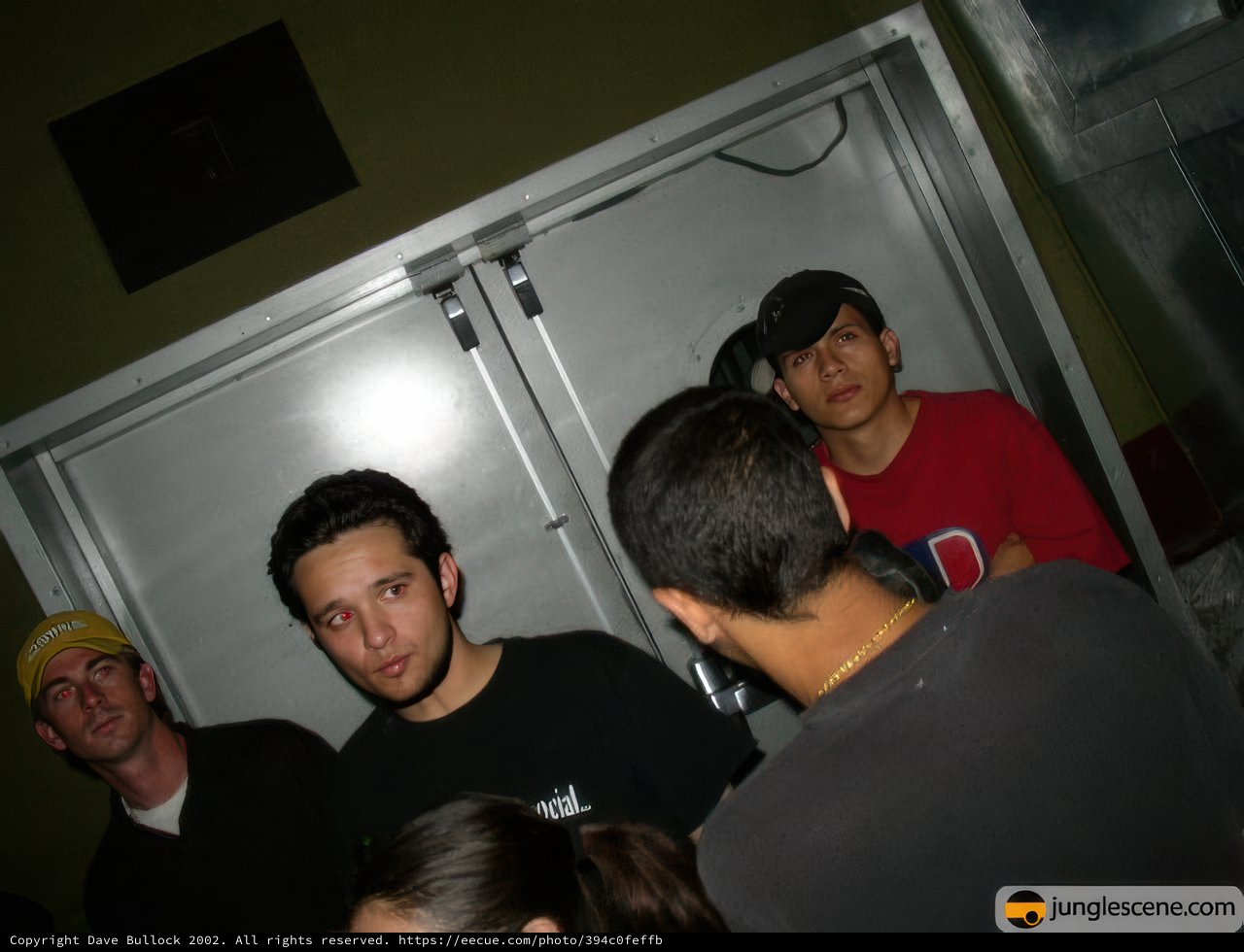 Group of Six People Standing in Front of a Door