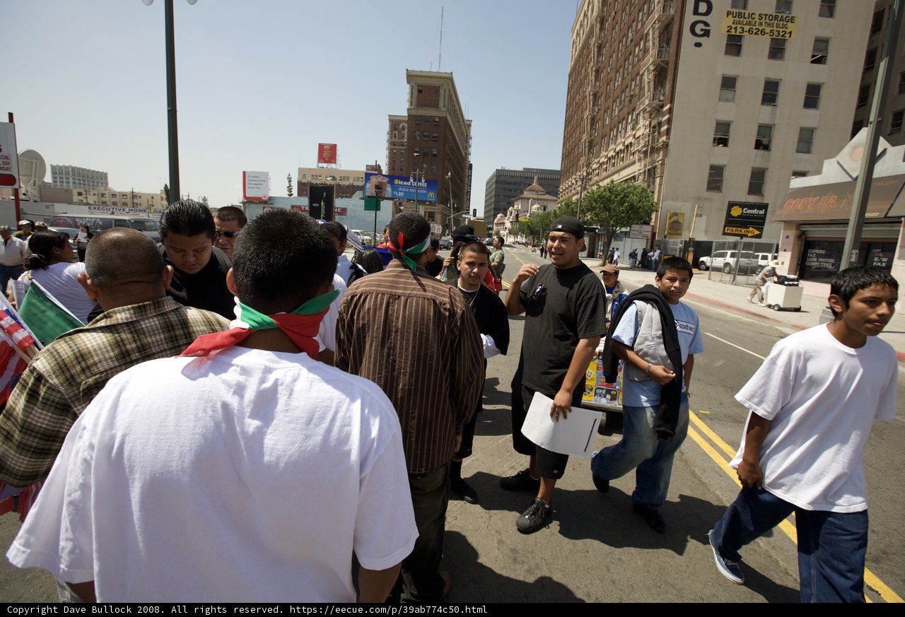 Mayday Rally Crowd Walking Down Urban Street