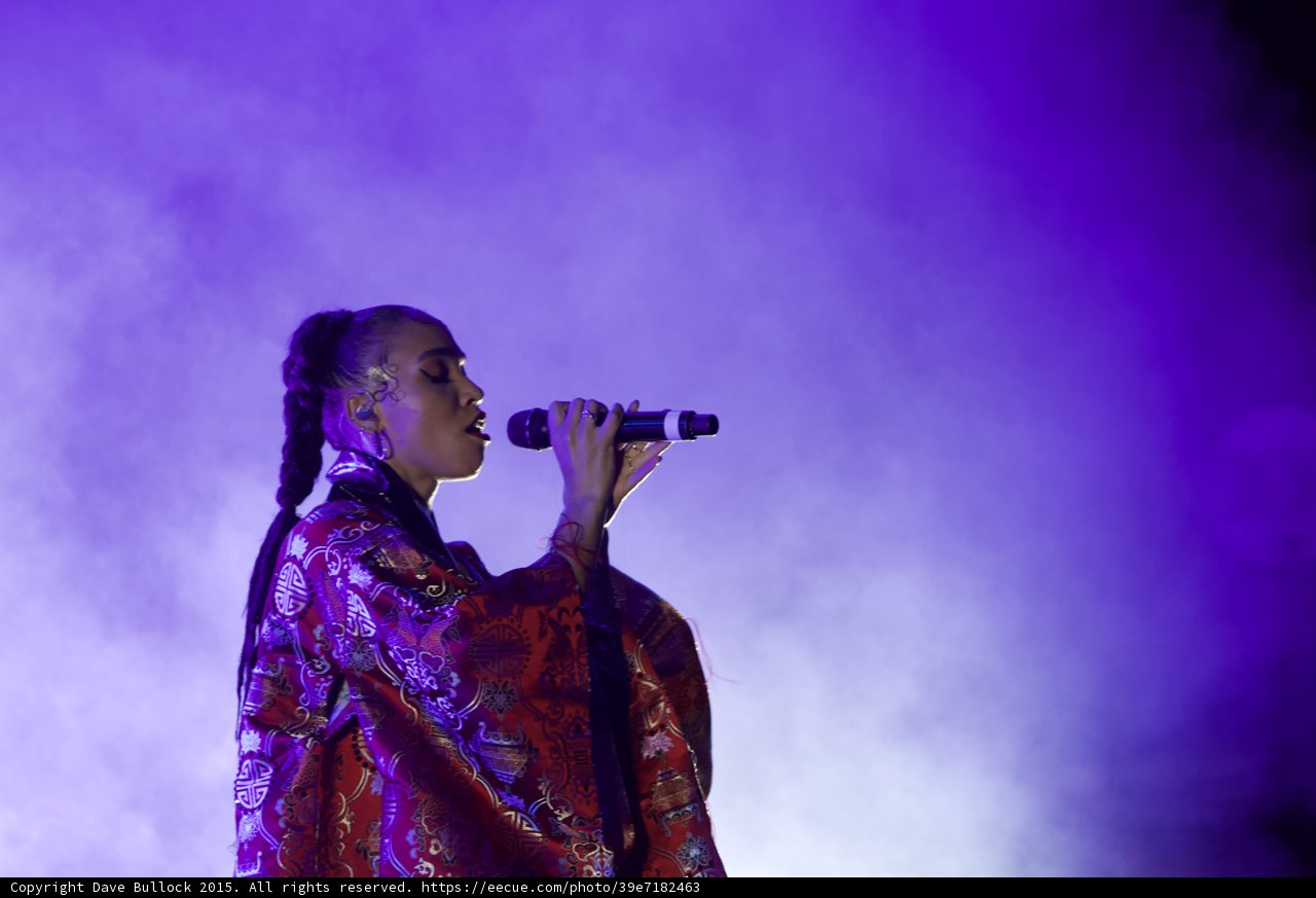 FKA twigs Beautiful Upper Body Profile Singing Eyes Closed Contemplative Baby Hairs Swirls Hoop Earrings Braided Ponytail Rings Kimono Red Brocade Gold Patterns Purple Blue Lighting Heavy White Haze