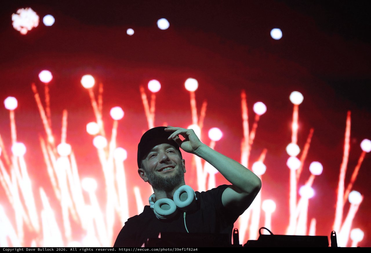 DJ Performs Under Dramatic Red Stage Lights