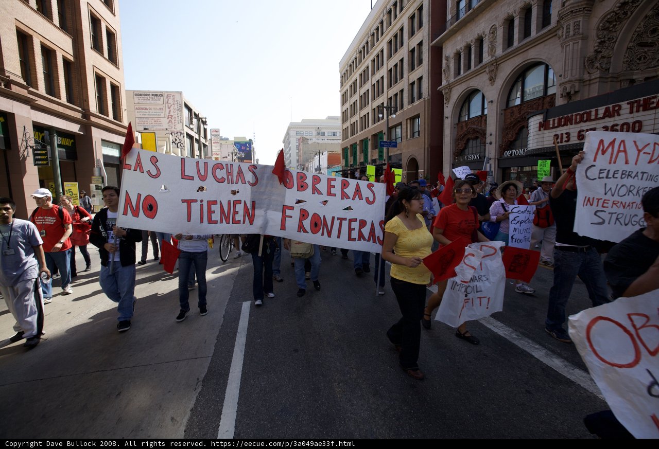 Mayday Rally Marchers Hold Up Banners and Signs