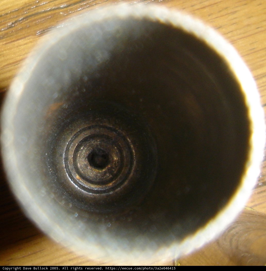 Metal Object in Pottery Cup