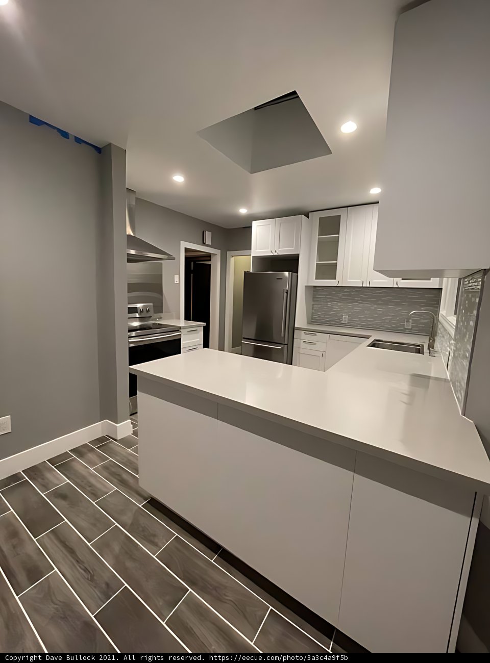 White Kitchen with Modern Appliances and Tile Flooring
